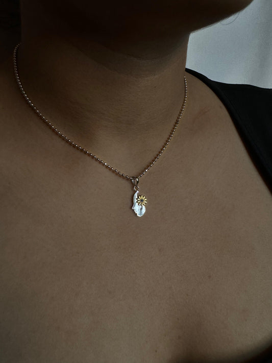 Women with flower pendant